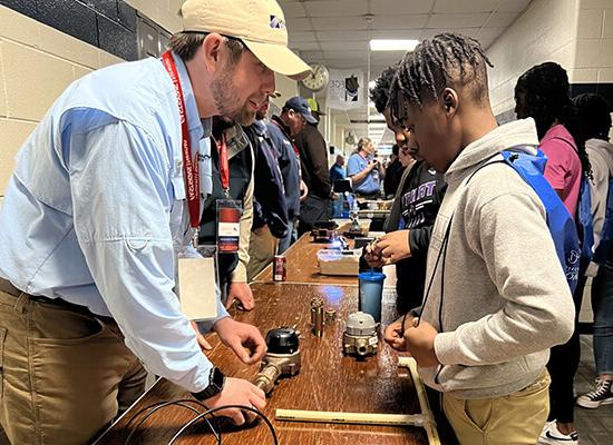 Newnan Utilities employee speaking to a student